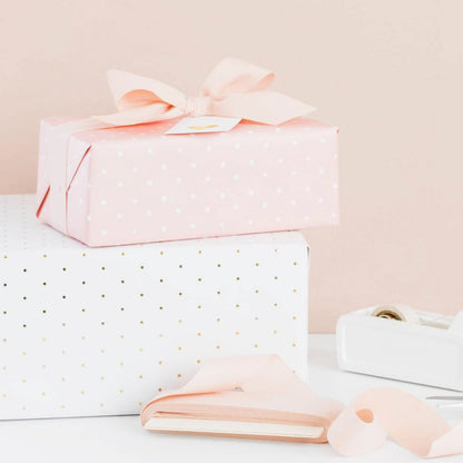 Stacked wrapped gifts with ribbon and tape