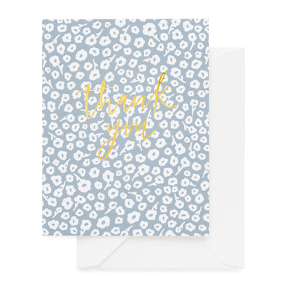 blue floral card with gold foil script and white envelope